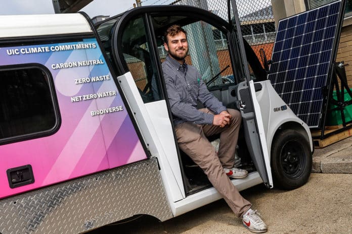 UIC student Joe Downie with the solar charge station.