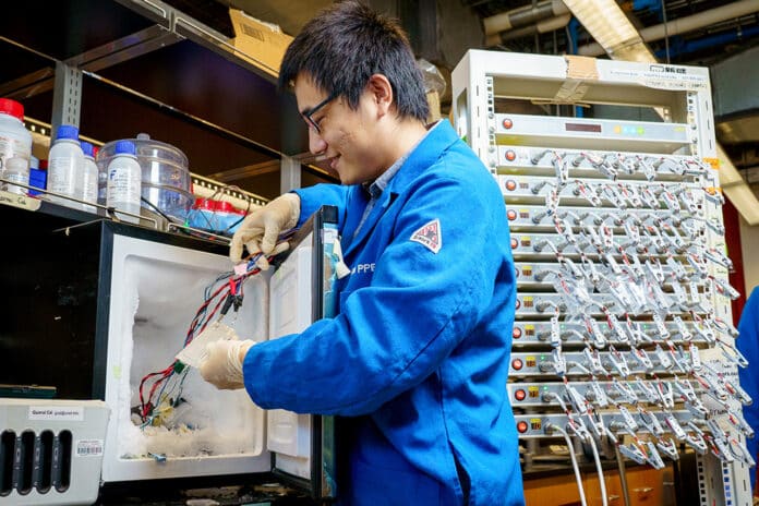 Study first author Guorui Cai, a nanoengineering postdoctoral researcher at UC San Diego, prepares a battery pouch cell for testing at subfreezing temperature.