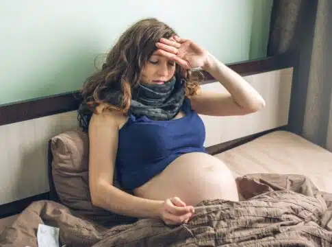 Young pregnant woman in bed