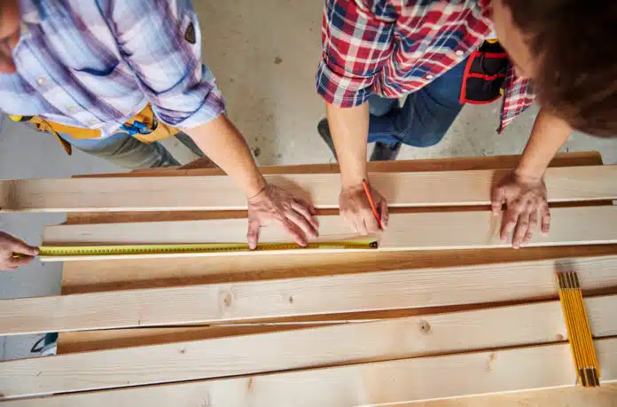 Collaboration of two carpenters in building