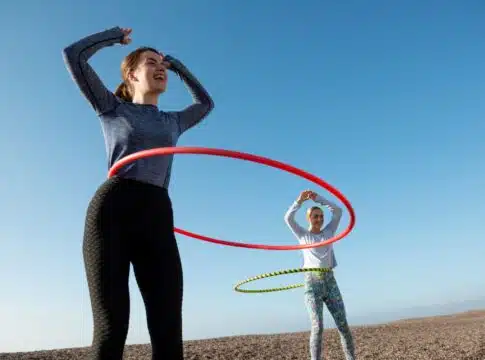 Women exercising with hula hoop circle