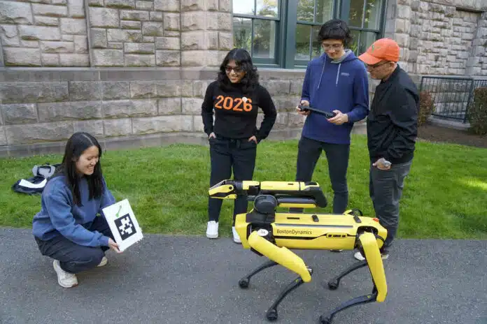 SPOT, a Boston Dynamics robot, performs tasks in response to QR codes. Vivian Chen ’25 holds the code, while Vasumathi Venkat ’25, Aaron Serianni ’25 and Prof. Alexander Glaser observe.