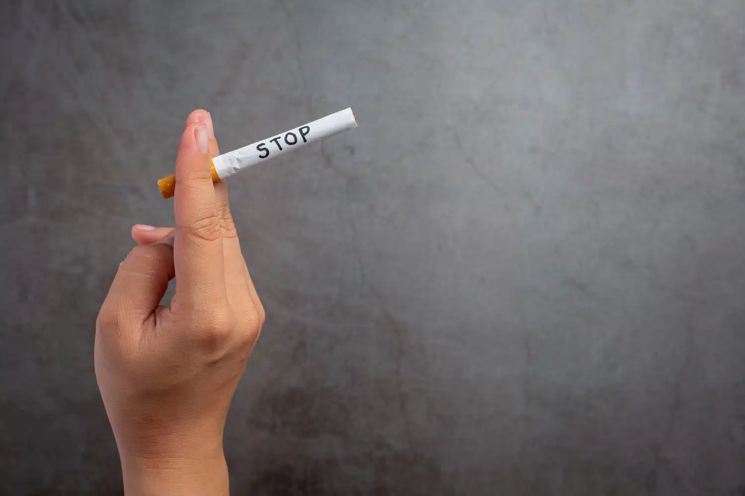 Human hand holding cigarette