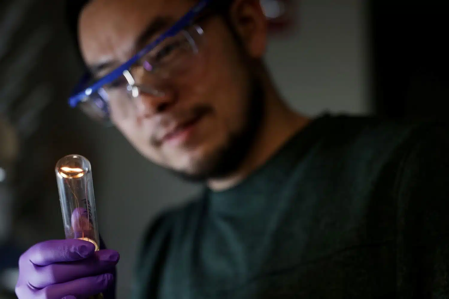 twisted filament glowing Jun Lu examines the twisted filament glowing within the bulb. He, along with a team of U-M researchers, demonstrated for the first time that a twisted filament could produce twirling light waves