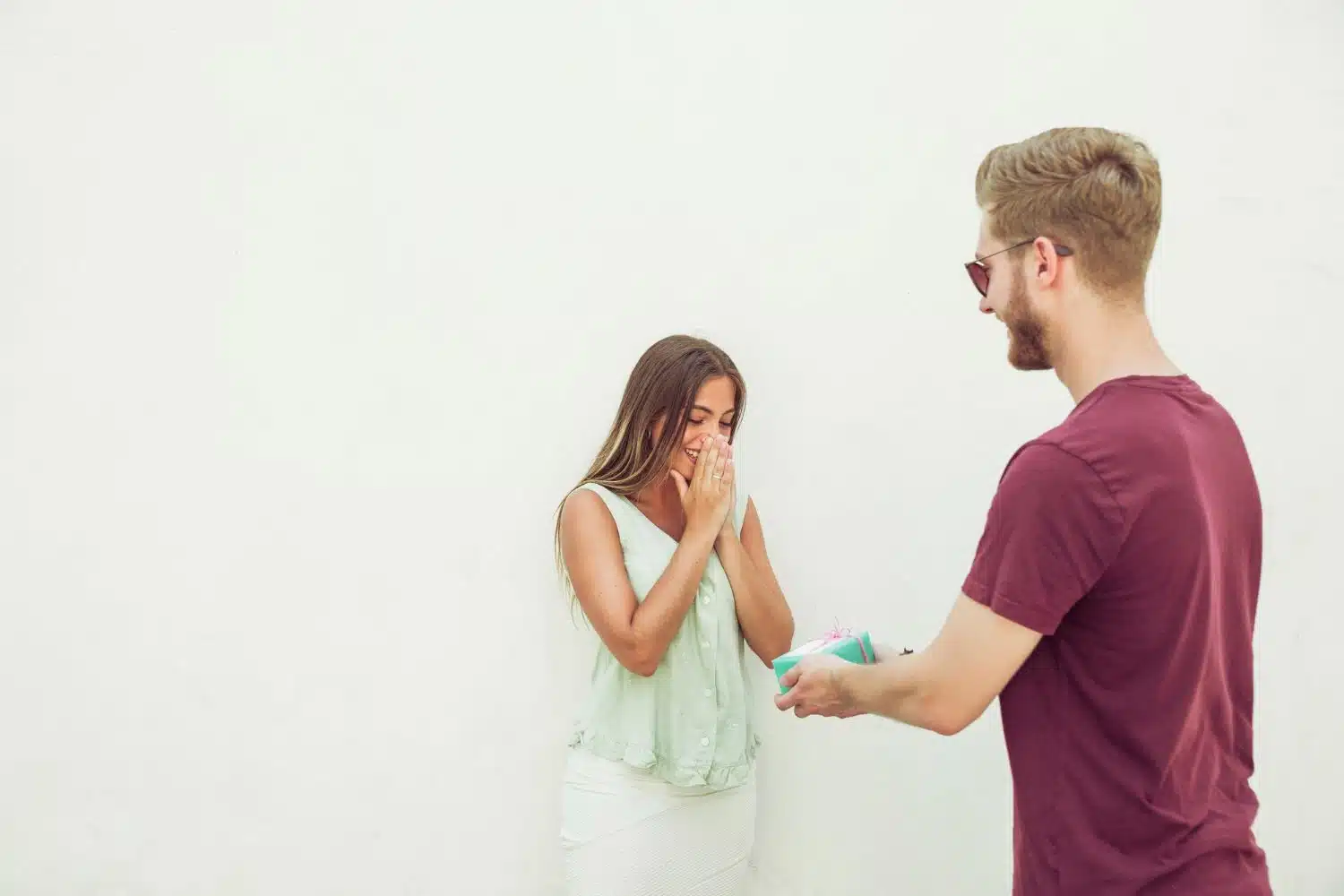 Man giving gift to his surprised girlfriend